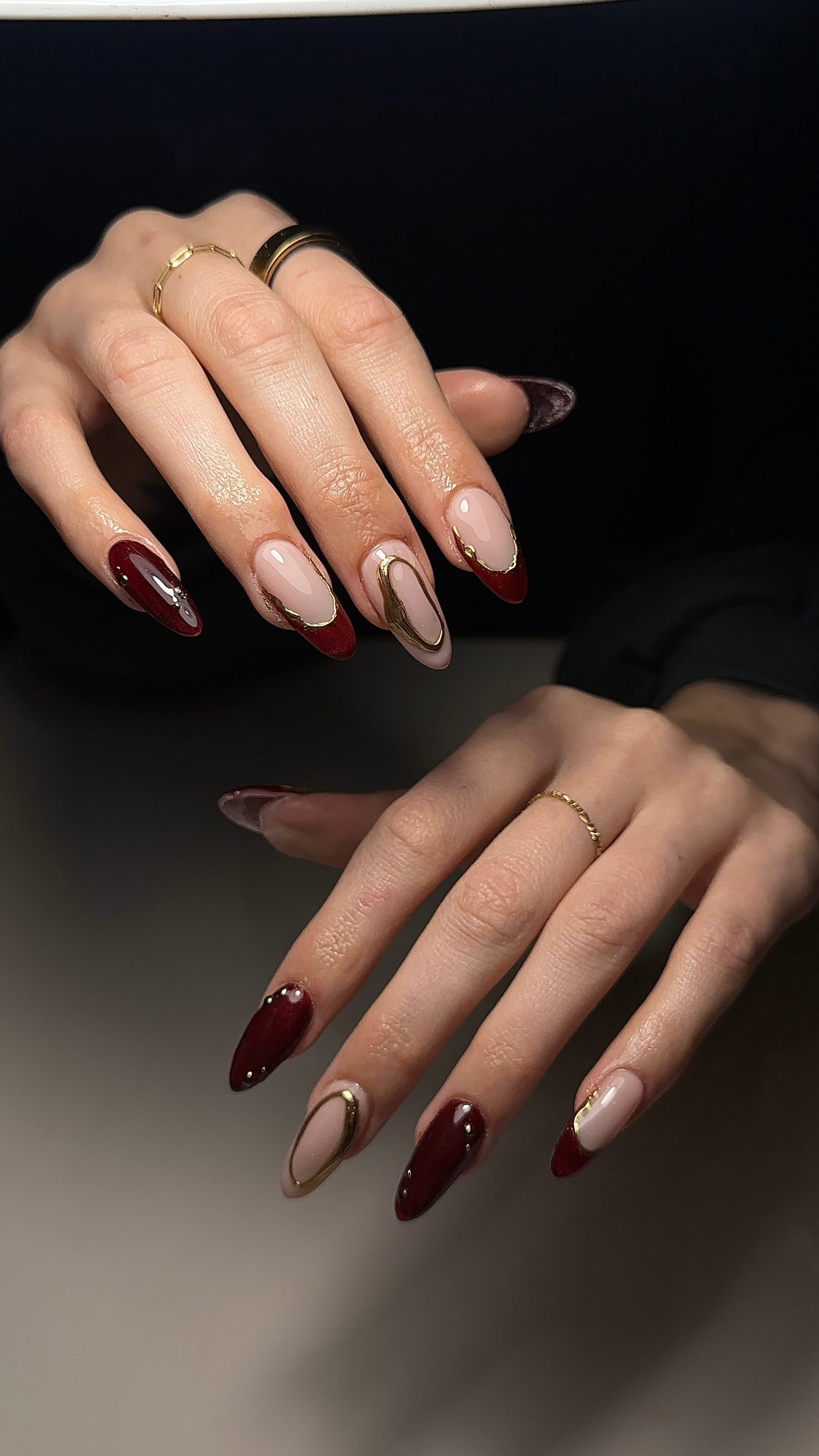 Burgundy French tip nails with gold accents