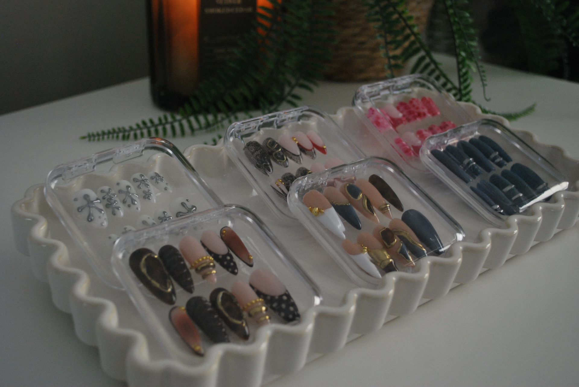 Set of luxury nude press-on nails with champagne shimmer on marble